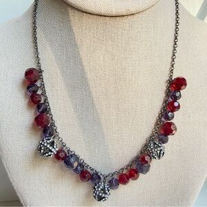 Gunmetal chain necklace with dangling translucent red and purple faceted beads
